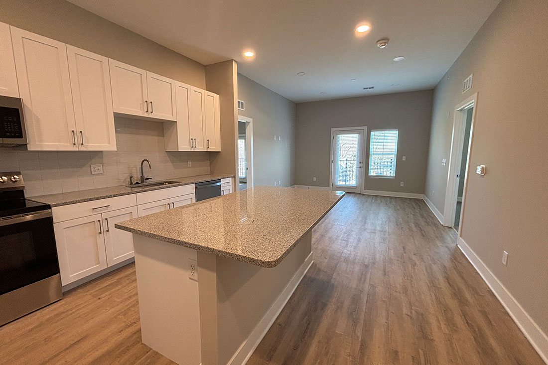 Bright and spacious living area and kitchen at Mission Flats Apartments in Mission, Kansas