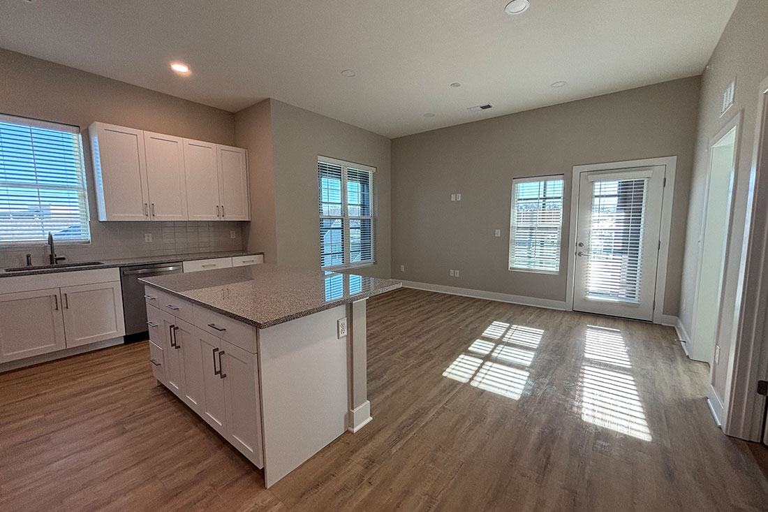 Bright and spacious living area and kitchen at Mission Flats Apartments in Mission, Kansas